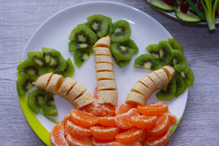 refreshing and healthy salad of kiwi, banana, mandarin