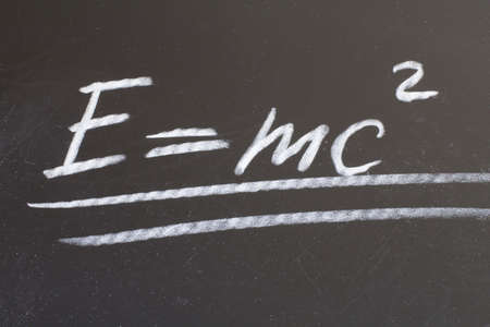 written in chalk on a blackboard mathematical formula