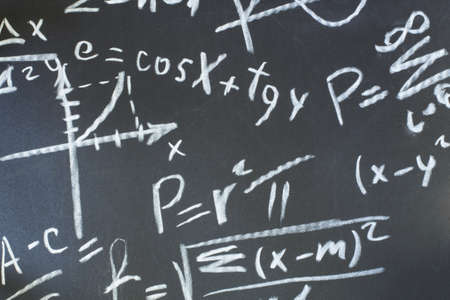 written in chalk on a blackboard mathematical formula