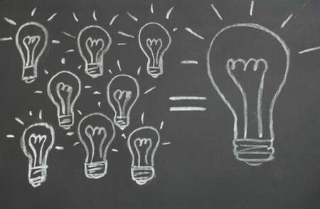 Blackboard with the image of a light bulbの写真素材