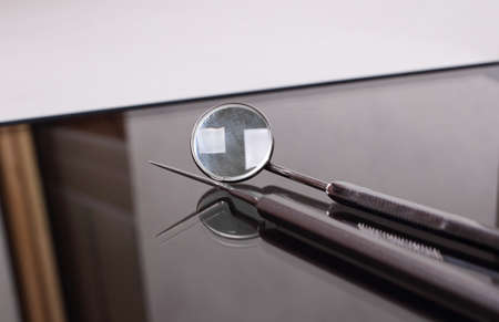 dental tools lying on a glass tableの写真素材