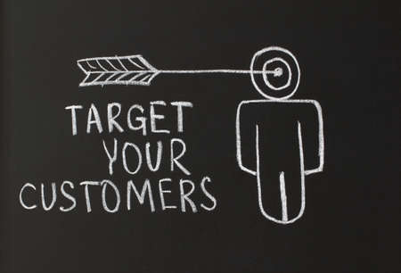 writing with chalk on a blackboardの写真素材