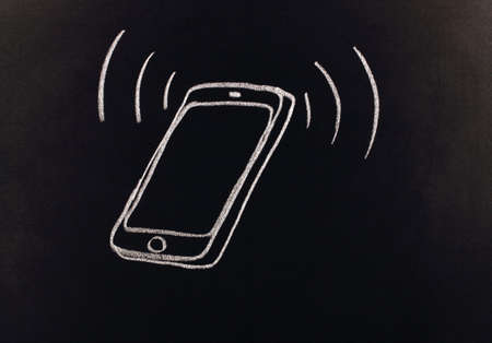 drawing with chalk on a blackboardの写真素材