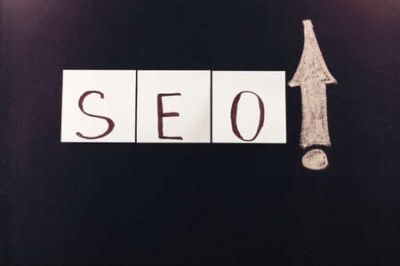 writing with chalk on a blackboardの写真素材