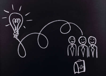 drawing with chalk on a blackboardの写真素材