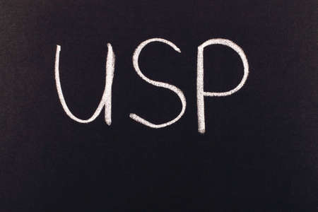 writing with chalk on a blackboardの写真素材