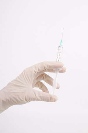 syringe in hand on white backgroundの写真素材