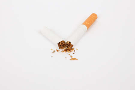 cigarette broken in half on a white backgroundの写真素材