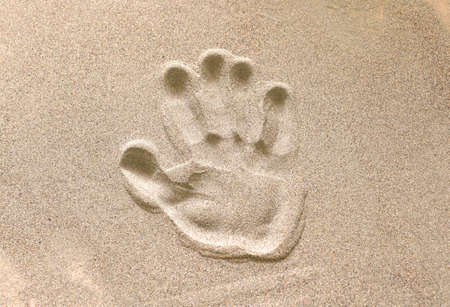 the imprint of the human hand in the sandの写真素材