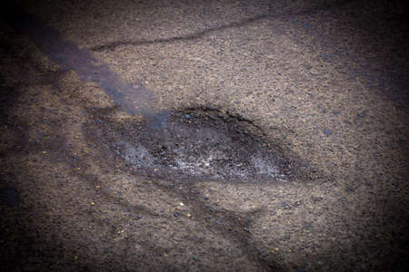 Pit on the road. Bad roadの写真素材