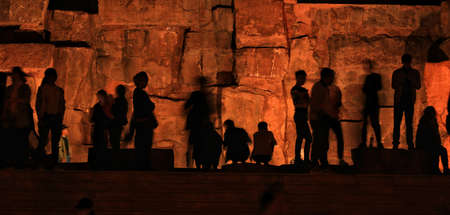 person silhouettes in front of the light