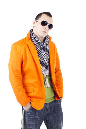 Young stylish guy with glasses waring orange jacket, sunglasses and earphonesの写真素材