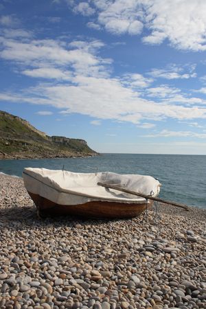 Wooden Boat on a pebble beachの写真素材