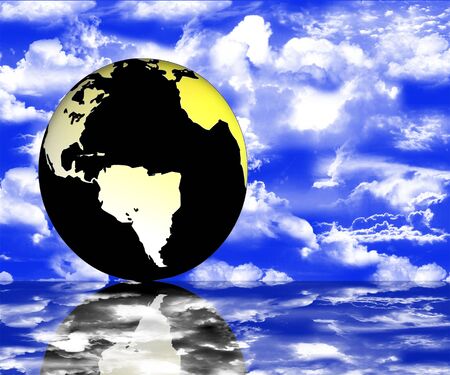 World globe with reflections on a blue cloudy sky backgroundの写真素材