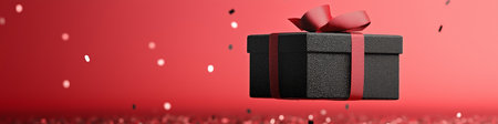 Elegant black gift box with red ribbon floating on red glitter with falling confetti, perfect for...