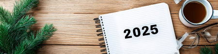 2025 goals written on notebook surrounded by christmas decorations and coffee