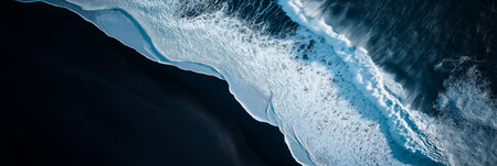 Stunning aerial perspective of ocean waves with white foam crashing on the black sand beach,...