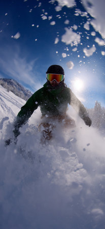 Snowboarder carving fresh powder snow on mountain slope. Snowboarding bannerの写真素材