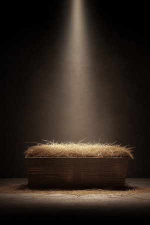 Empty wooden manger with straw receiving warm light, symbolizing birth and new beginnings. Wooden...