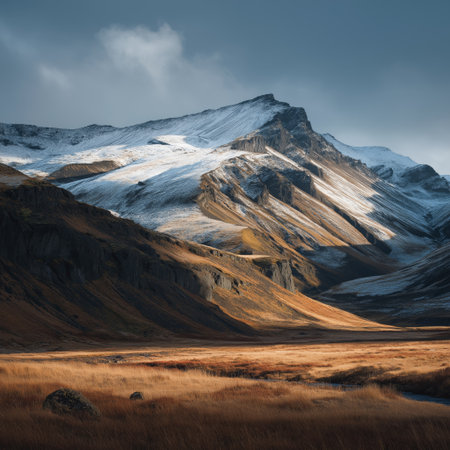Lush green Icelandic valley with rugged mountains under a cloudy sky. Icelandic valley with impressive green mountains and dramatic skyの写真素材