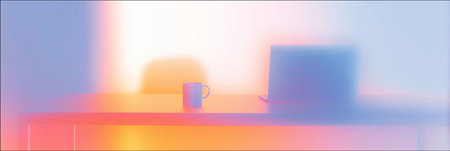 Blurry mug and laptop on desk with bright gradients representing work from home. Blurry desk with mug and laptop creating home office conceptの写真素材