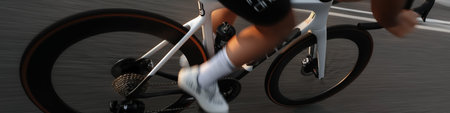 Cyclist riding bicycle with motion blur, emphasizing speed, fitness, and movement. Cyclist...
