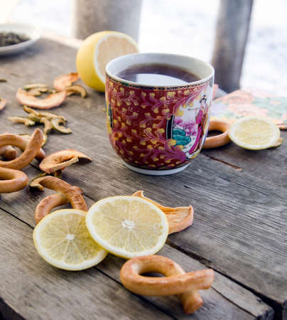 Cup of tea with lemon on a wooden tableの写真素材