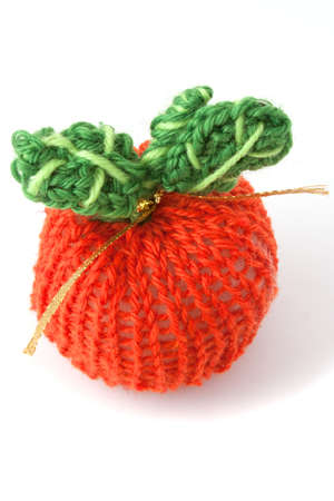 knit apple red with green leaves on white backgroundの写真素材