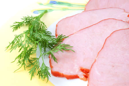 ham with vegetables sliced on a plate closeup