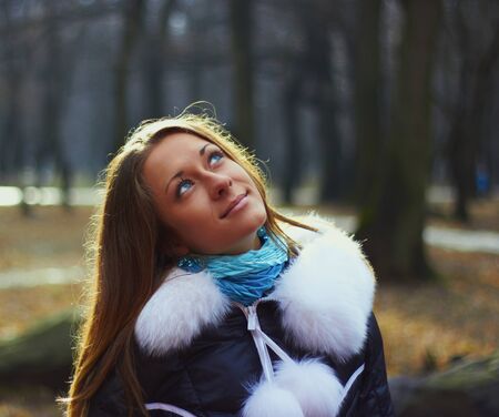 Girl in park looks in the skyの写真素材