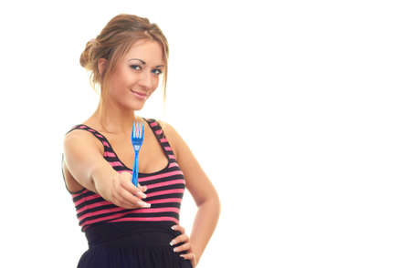 young girl with a fork in her hand isolated on white backgroundの写真素材