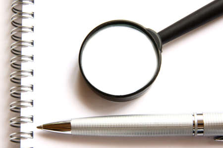Pen, notebook and magnifierの写真素材