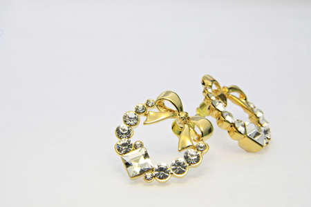 Gold earrings on the white backgroundの写真素材