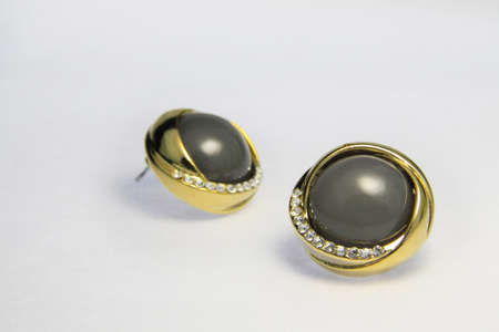 Gold earrings on the white backgroundの写真素材