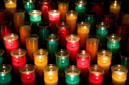 Candles in color glasses in a churchの写真素材