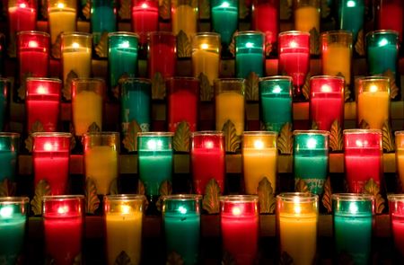 Candles in color glasses in a churchの写真素材