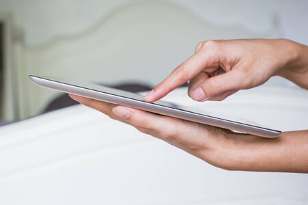 Woman hand on tablet pc, access for knowlwdgeの写真素材