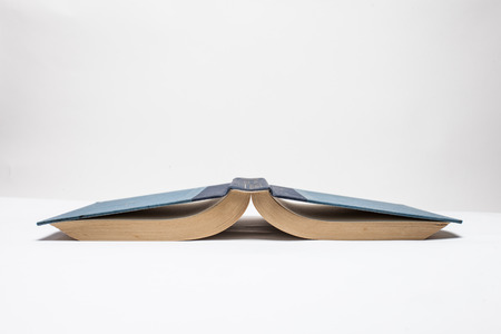 Book up side down on white background.