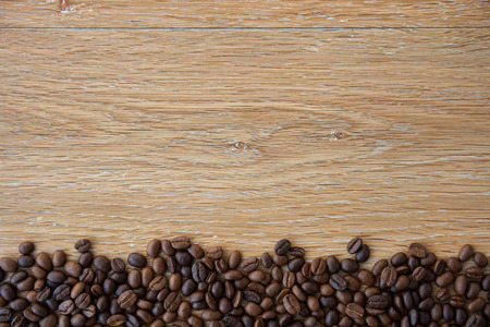 Coffee beans on wood backgroundの写真素材