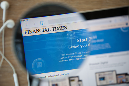 CHIANGMAI, THAILAND - February 26, 2015: Photo of The Financial Times homepage on a ipad monitor screen through a magnifying glass.のeditorial素材