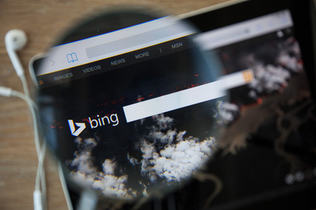 CHIANGMAI, THAILAND - February 26, 2015: Photo of Bing homepage on a ipad monitor screen through a magnifying glass.のeditorial素材