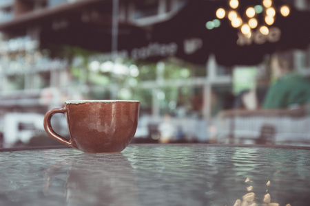 vintage tone of cup of coffee on table in Coffee shop blur background with bokeh image.の写真素材