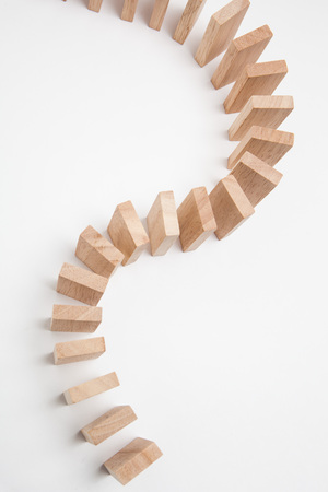 Domino effect - row of white dominoes on white backgroundの写真素材