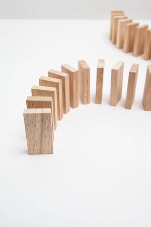 Domino effect - row of white dominoes on white background