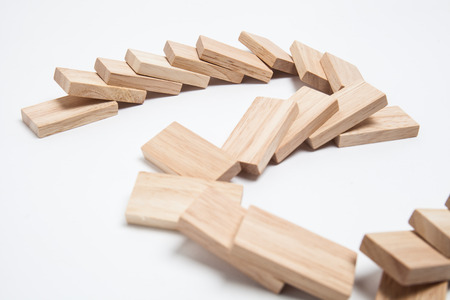 Domino effect - row of white dominoes on white backgroundの写真素材