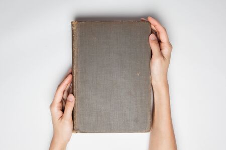 hands hold the  book cover isolated white.の写真素材