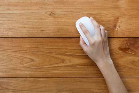 Female hand holding a mouse.の写真素材