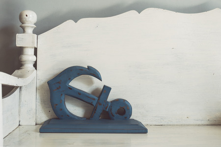 Vintage tone of old nautical anchor on wooden benchの写真素材