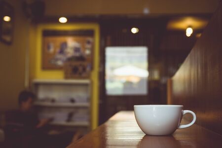 Vintage tone of cup of coffee on table in cafe