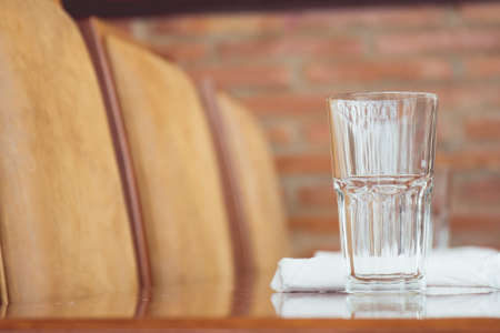 A glass of water on a tableの写真素材